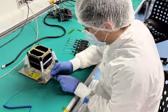 Student working on CubeSat Satellite. Picture by European Space Agency ESA. 