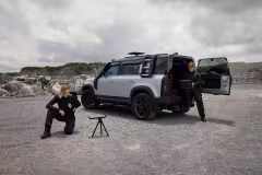 ICEYE / Nokia satellite terminal on tripod next to a Land Rover Defender