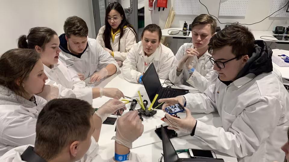 Learners studying a satellite